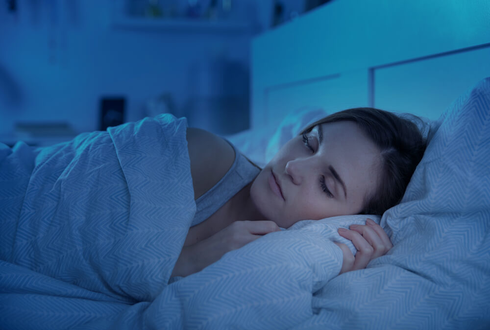 Woman peacefully sleeping in bed